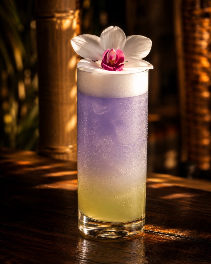Dok Champa Fizz with butterfly pea fade and an orchid on top