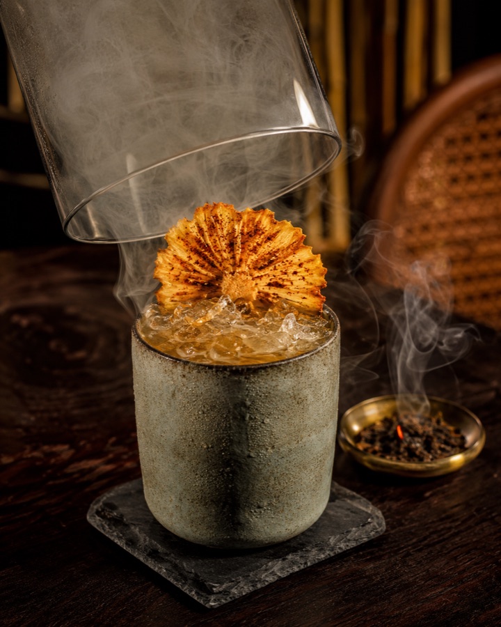 Khaen Fire under a smoke-filled glass cloche